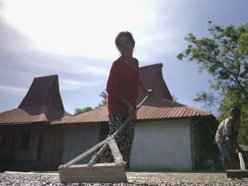 Raking cashews to dry in the sun at the Muntigunung processing centre